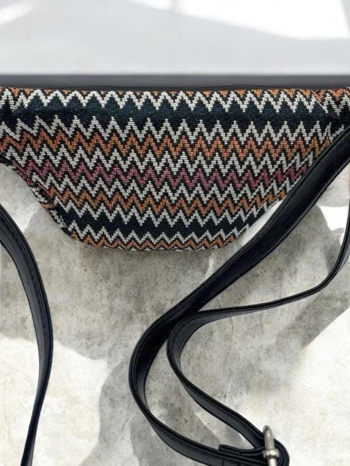 Trendy zigzag patterned bum bag with black strap on light stone background, Le Petit Placard