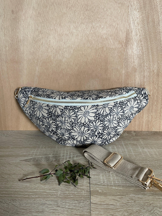 Floral print sac banane with beige strap on wood, trendy accessory at Le Petit Placard