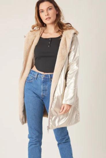Woman models a reversible metallic coat with faux fur lining, classic streetwear style