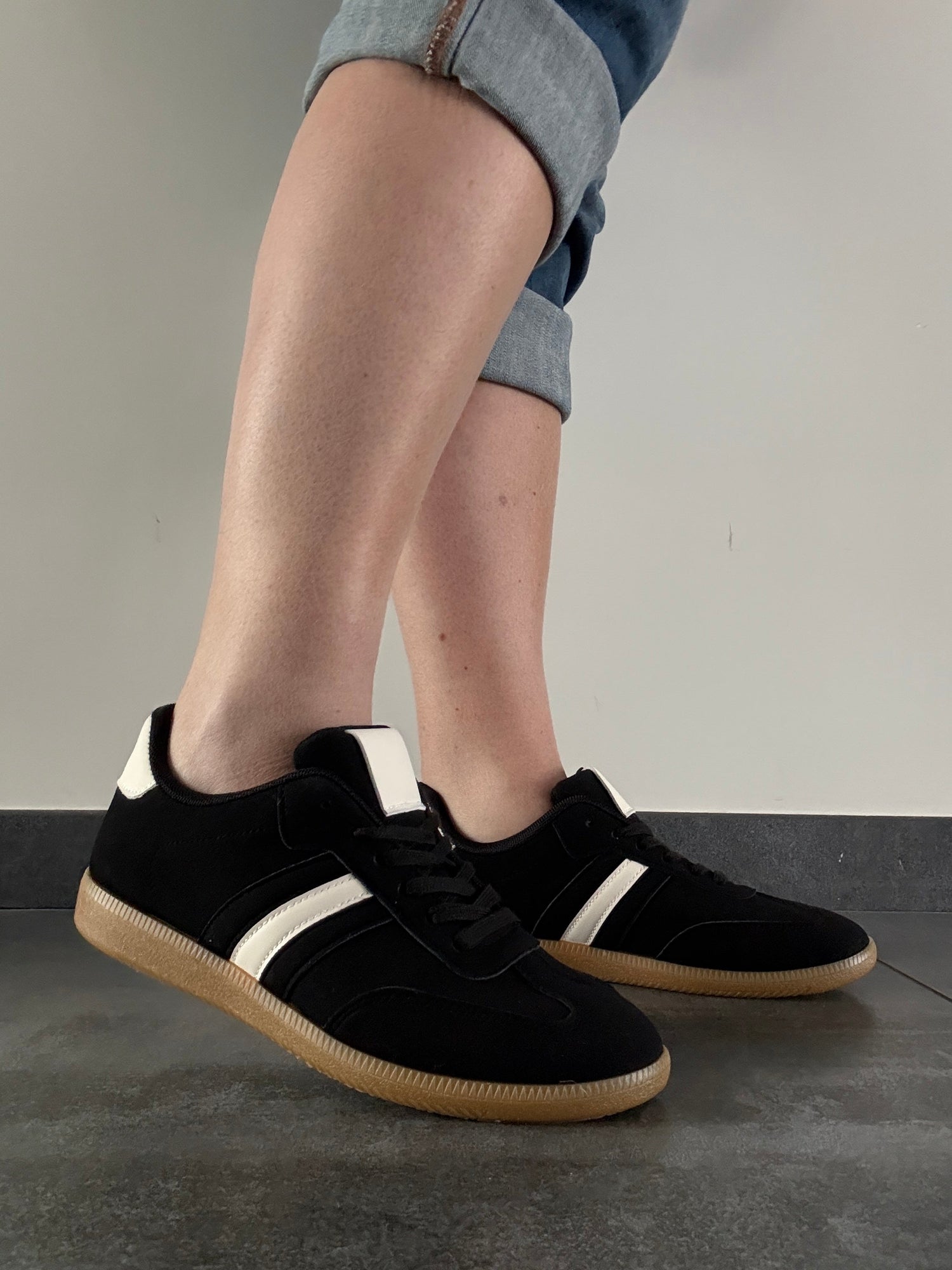 Black and white sneakers with gum soles worn with rolled-up jeans, Le Petit Placard style