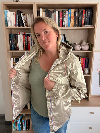 Femme ouvrant la parka dorée Laura Jo pour montrer la doublure intérieure et le côté réversible