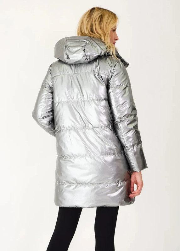 Woman wearing a long silver reversible puffer raincoat from Le Petit Placard