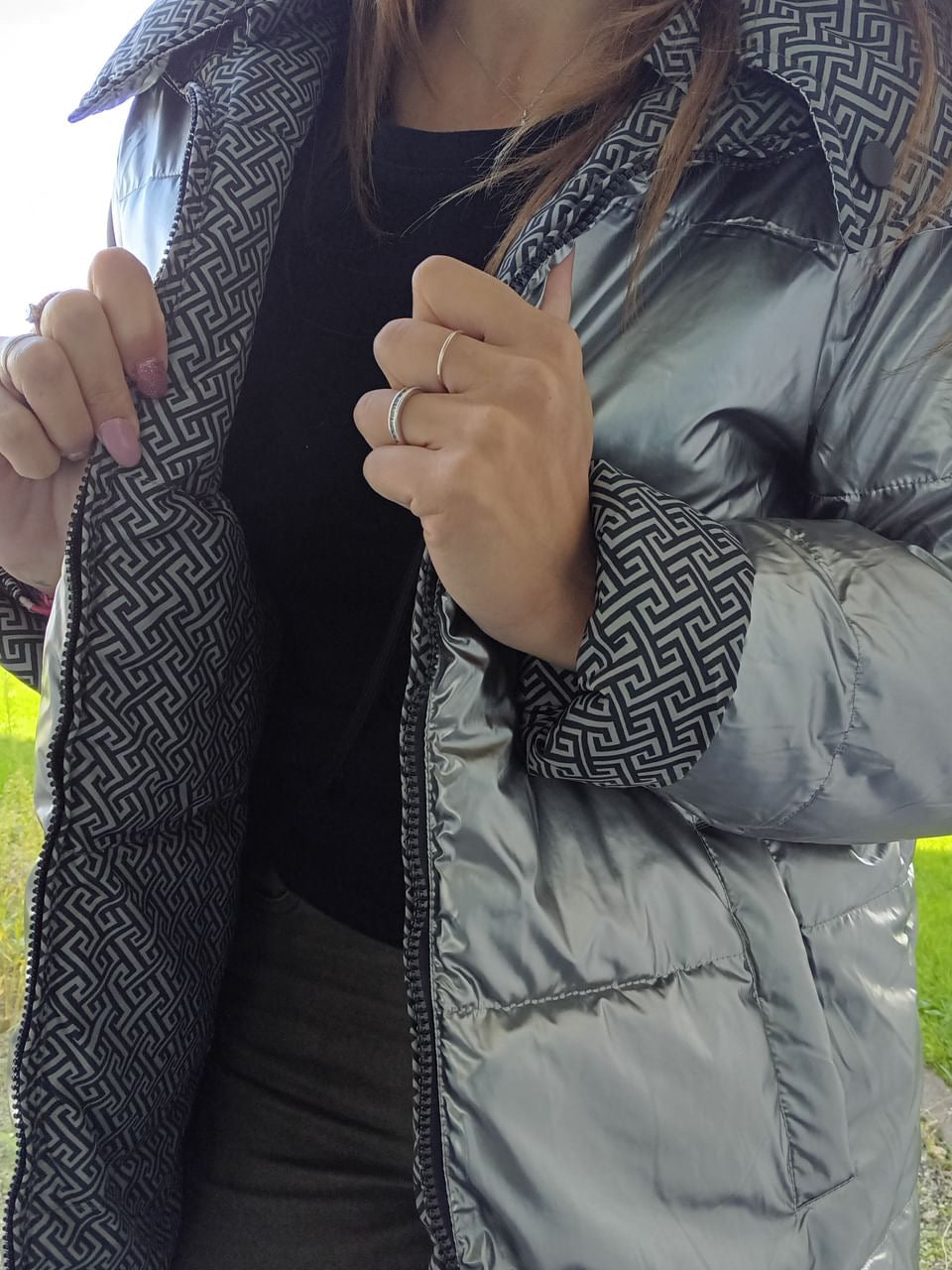 Woman wearing reversible silver quilted raincoat with geometric lining, Le Petit Placard
