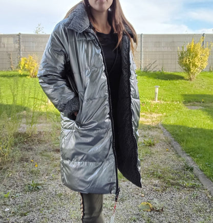 Woman wearing long reversible silver quilted raincoat Escandelle in outdoor garden, Le Petit Placard