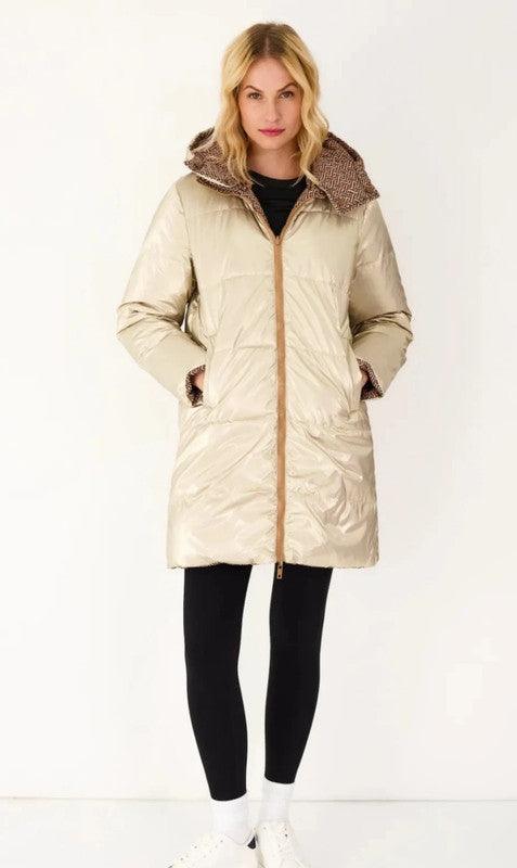 Woman in a gold reversible waterproof puffer coat from Le Petit Placard, hands in pockets