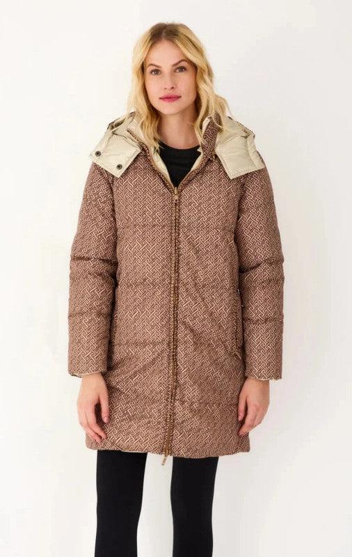 Woman wearing a brown reversible quilted waterproof coat from Le Petit Placard, front view