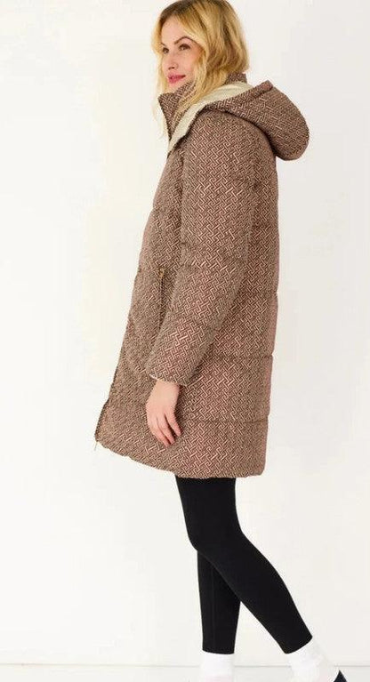 Woman wearing long reversible brown quilted waterproof coat with hood, Le Petit Placard