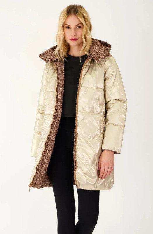Woman wearing a long reversible beige and brown padded waterproof coat from Le Petit Placard