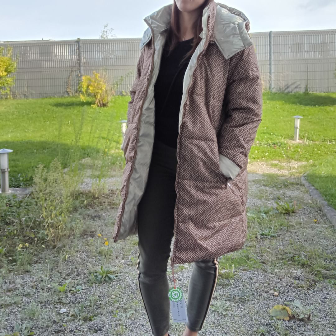 Woman wearing Escandelle long reversible quilted brown waterproof coat outdoors, Le Petit Placard