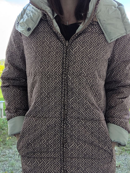 Woman wearing reversible brown and gold quilted waterproof coat from Le Petit Placard