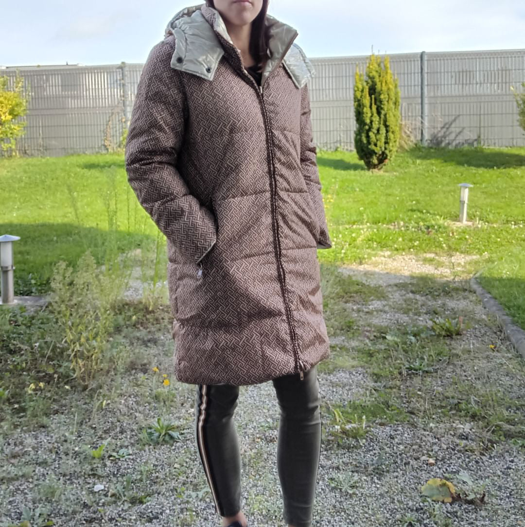 Woman wearing a reversible waterproof long brown coat, outdoors, Le Petit Placard fashion