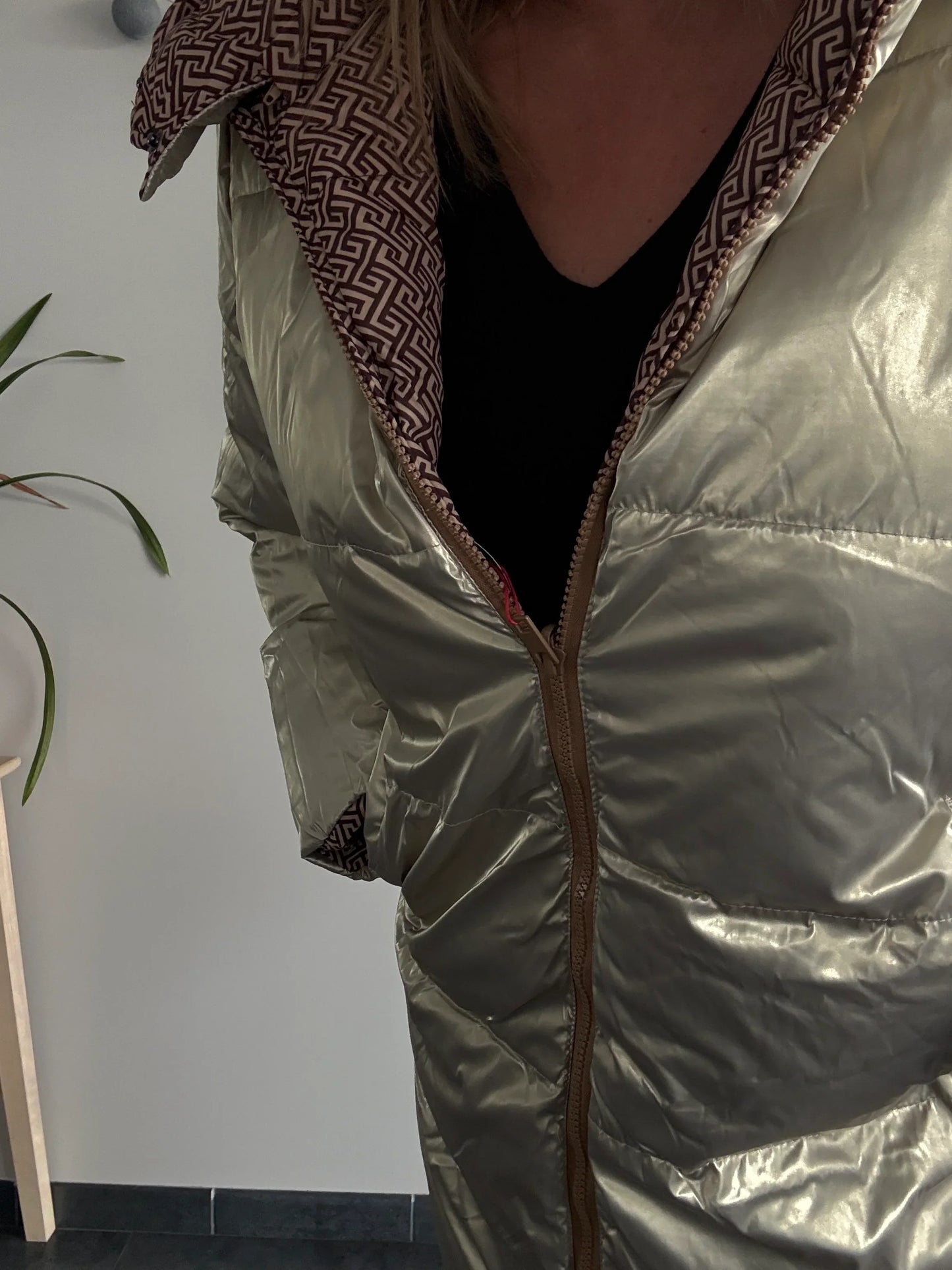 Woman wearing shiny metallic puffer jacket with patterned hood, Le Petit Placard fashion