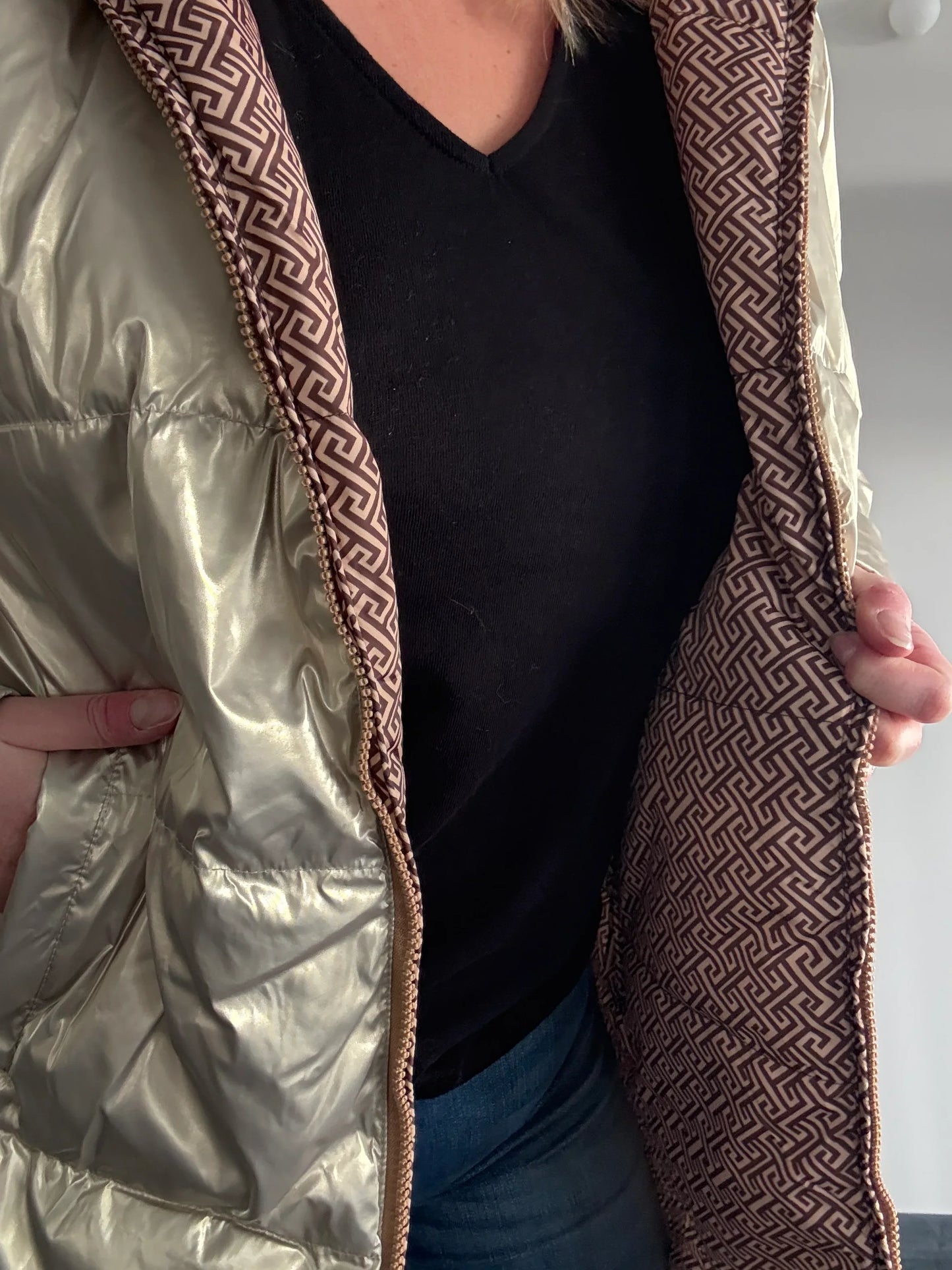 Woman wearing shiny Laura Jo raincoat with geometric brown patterned lining, Le Petit Placard