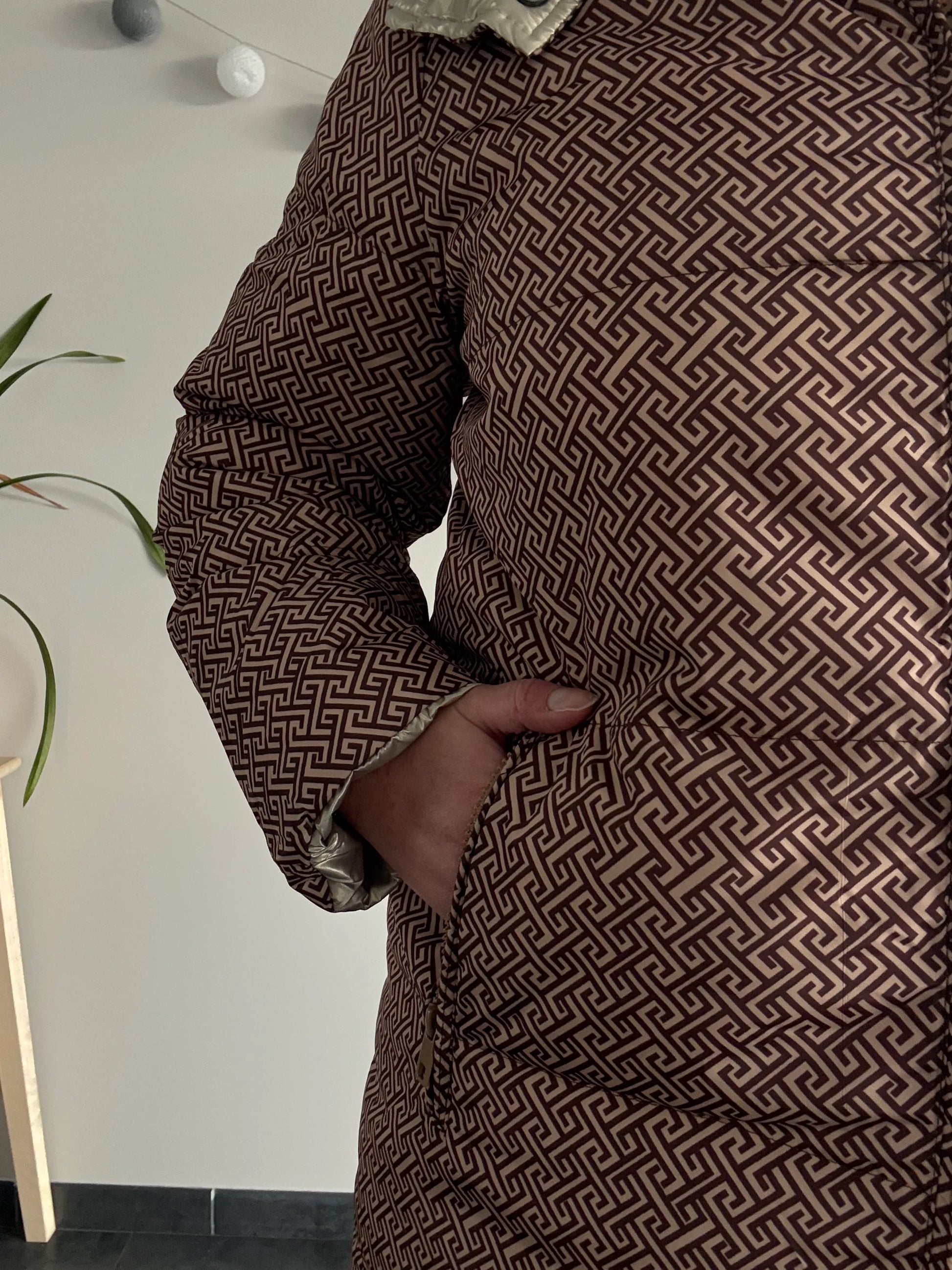 Close-up of Laura Jo patterned brown waterproof jacket at Le Petit Placard
