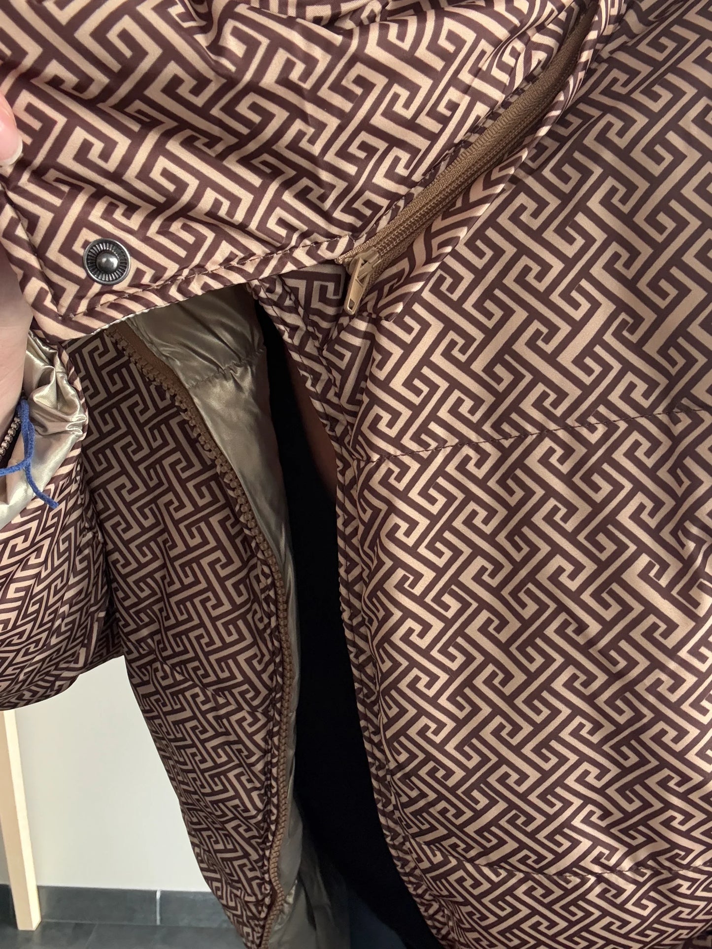 Close-up of Laura Jo geometric patterned raincoat with zipper, Le Petit Placard fashion