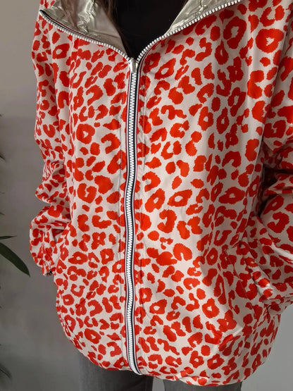 Parka imperméable courte réversible léopard orange et doré femme Escandelle – Capuche, coupe tendance et style 2-en-1 Escandelle