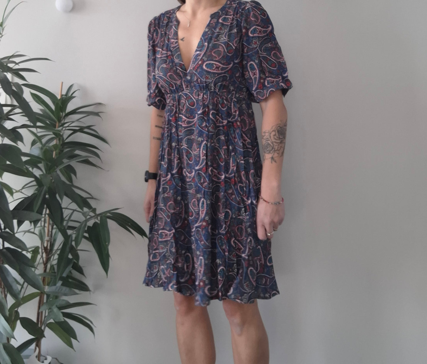 Woman wearing paisley print midi dress standing by indoor plant, Le Petit Placard fashion