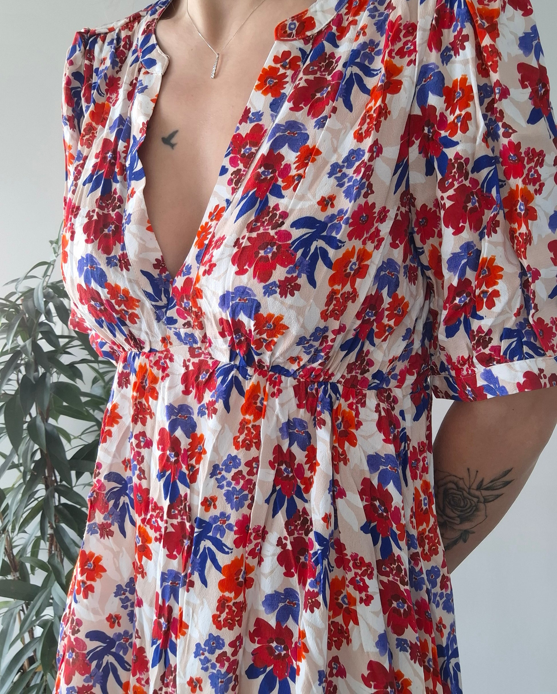 Colorful floral dress with red, blue, and orange flowers, model standing indoors, Le Petit Placard