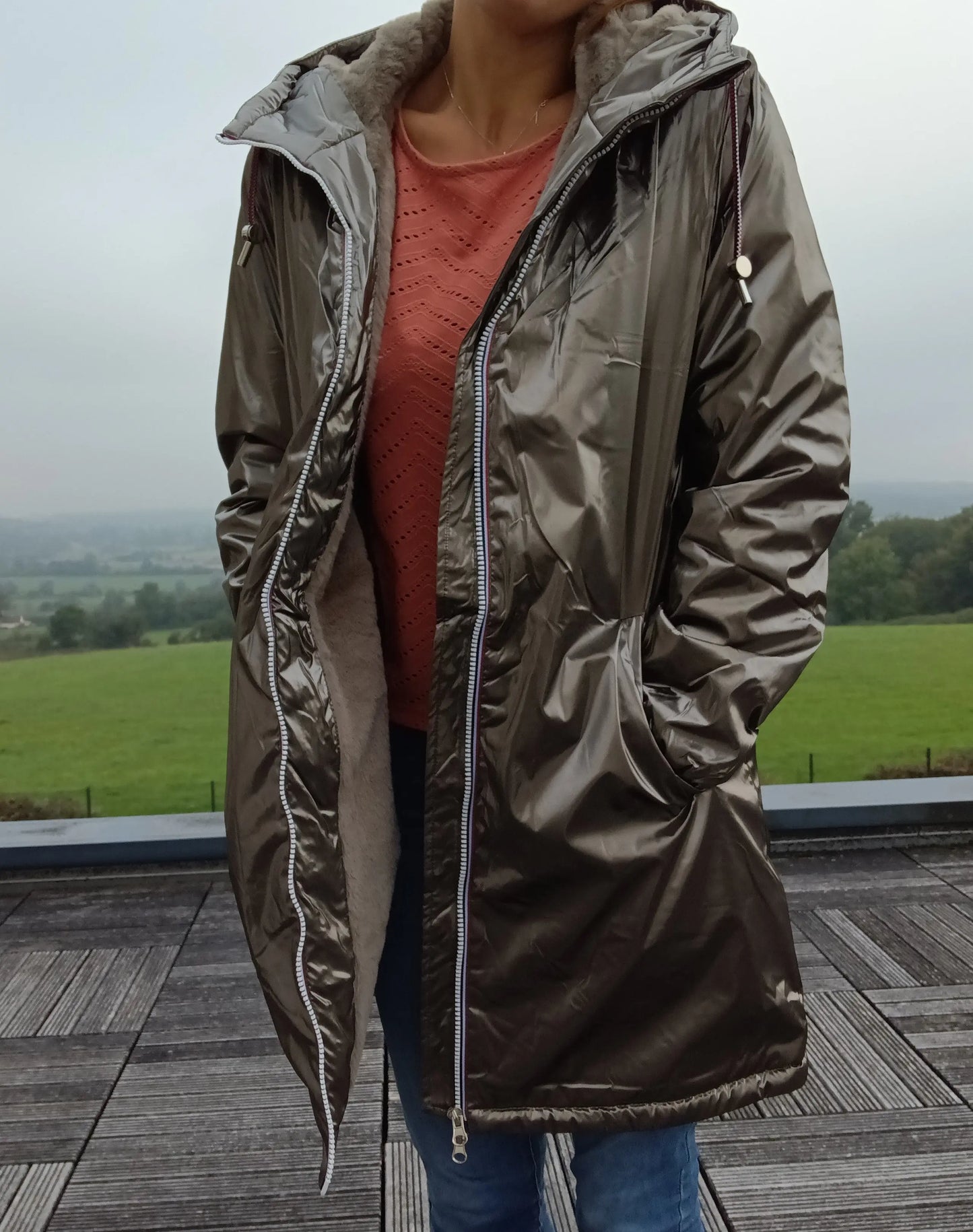 Woman wearing bronze Laura Jo raincoat, outdoor terrace, stylish winter outerwear at Le Petit Placard