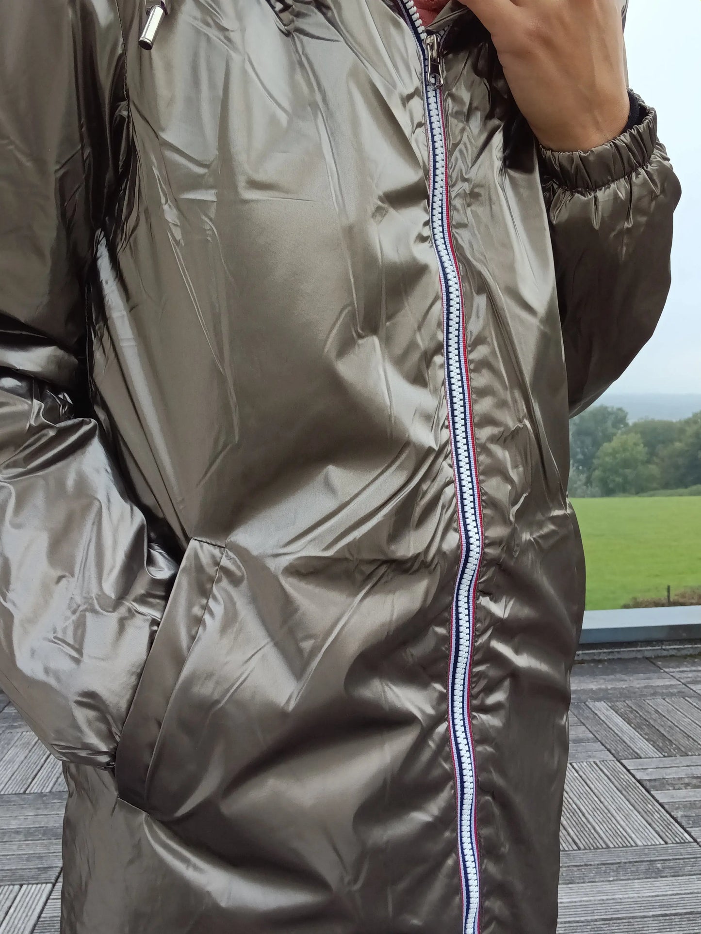Bronze Laura Jo rain jacket with zipper, shown outdoors on terrace, Le Petit Placard