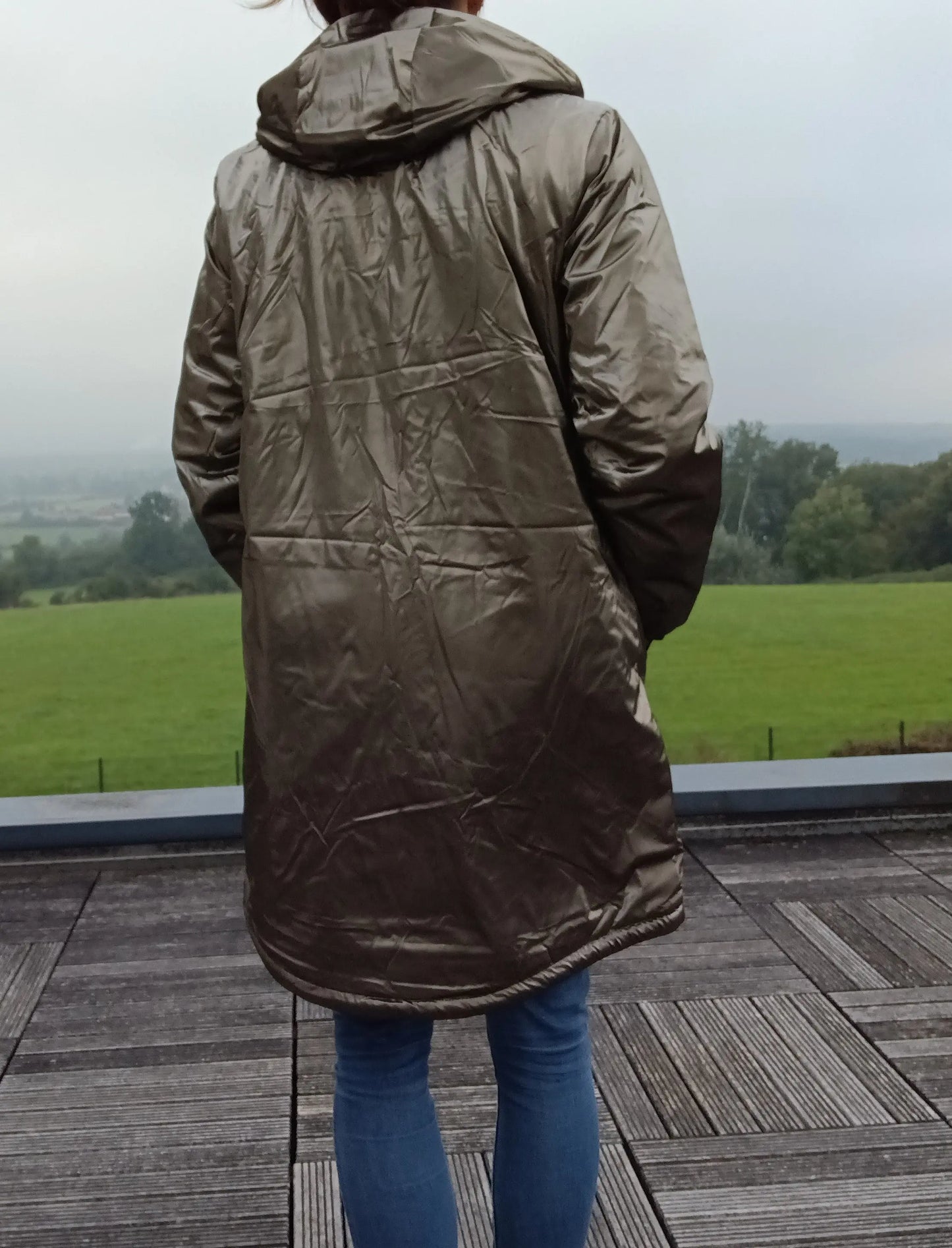 Woman wearing metallic bronze raincoat outdoor, Le Petit Placard fashion accessory