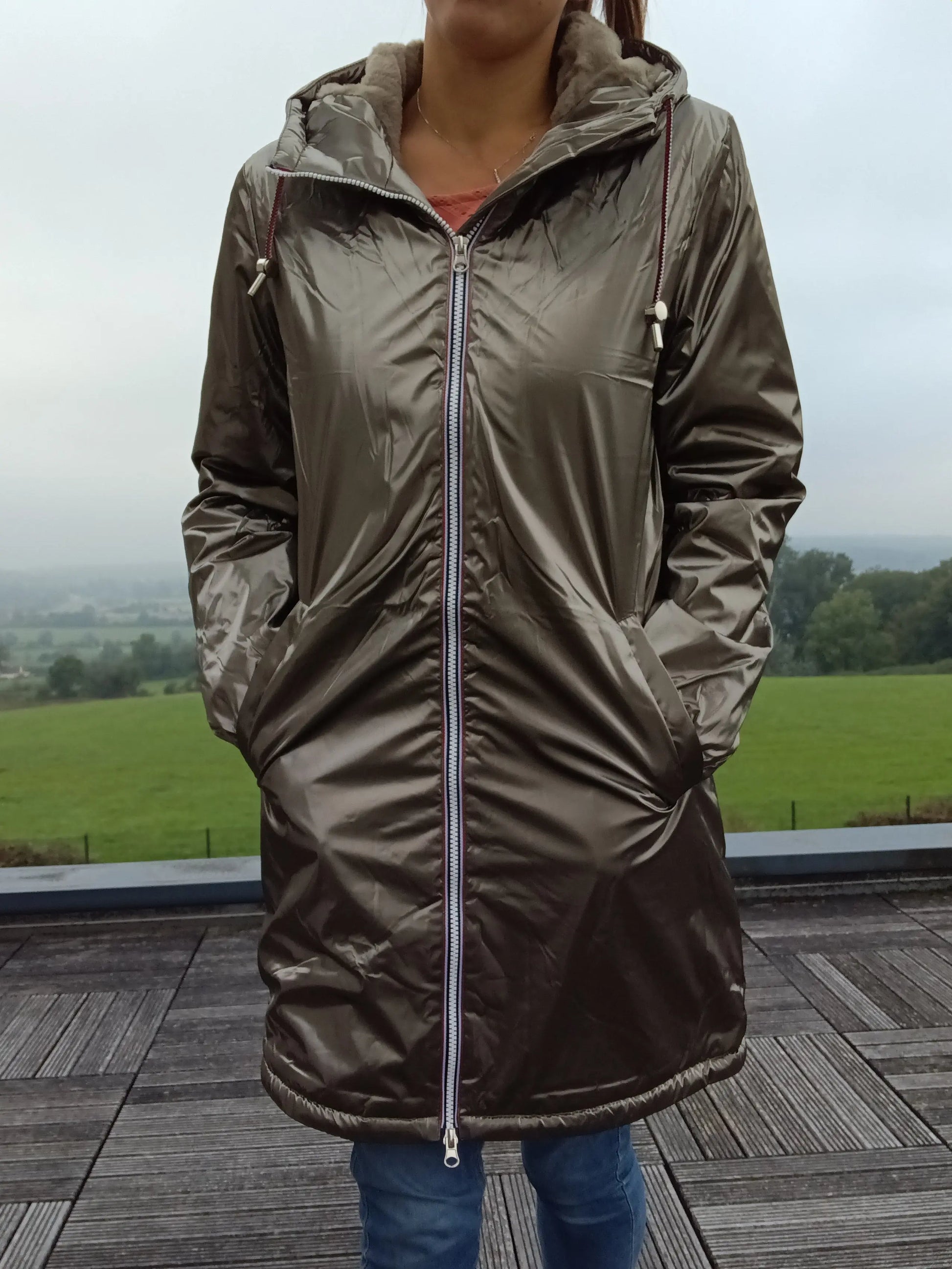 Woman wearing a shiny bronze Laura Jo raincoat outdoors, featured on Le Petit Placard