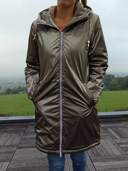 Woman wearing a shiny bronze Laura Jo raincoat outdoors, featured on Le Petit Placard