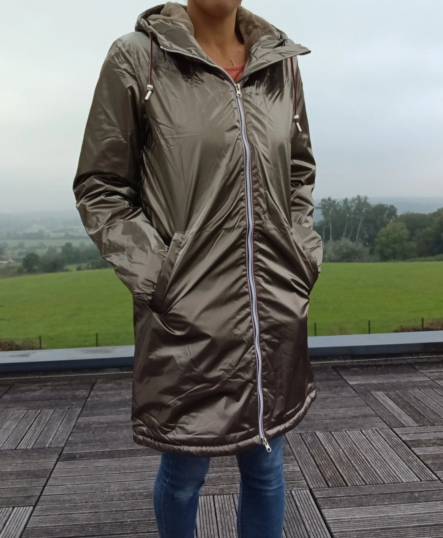 Woman wearing a bronze Laura Jo raincoat outdoors, stylish waterproof jacket Le Petit Placard