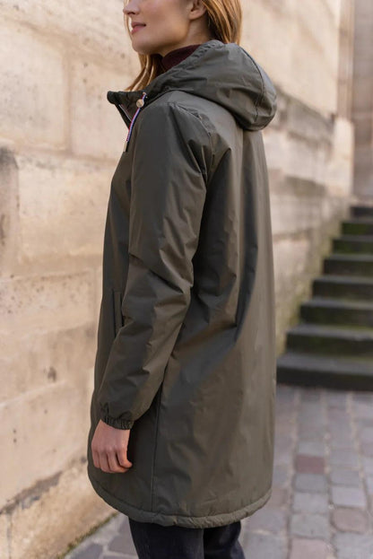 Woman wearing Laura Jo khaki long raincoat with hood and tricolour cord, outdoors
