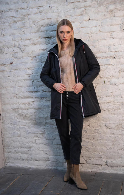 Woman wearing Laura Jo black long waterproof coat with faux fur trim and tricolor cord, Le Petit Placard