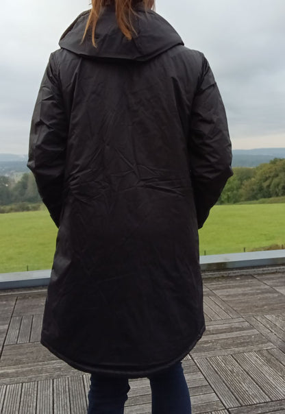 Woman wearing a long black Laura Jo raincoat outdoors, Le Petit Placard fashion