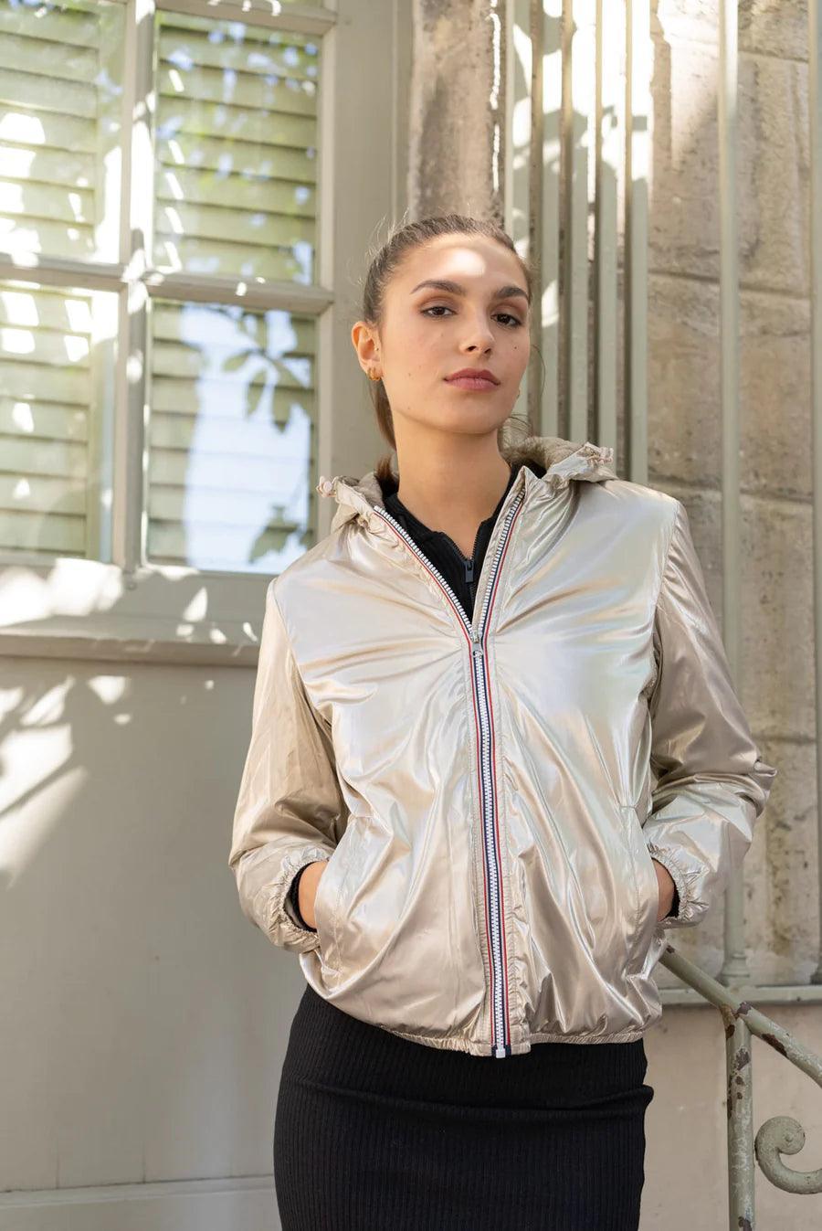 Woman wearing a shiny gold Laura Jo short waterproof jacket, Le Petit Placard collection