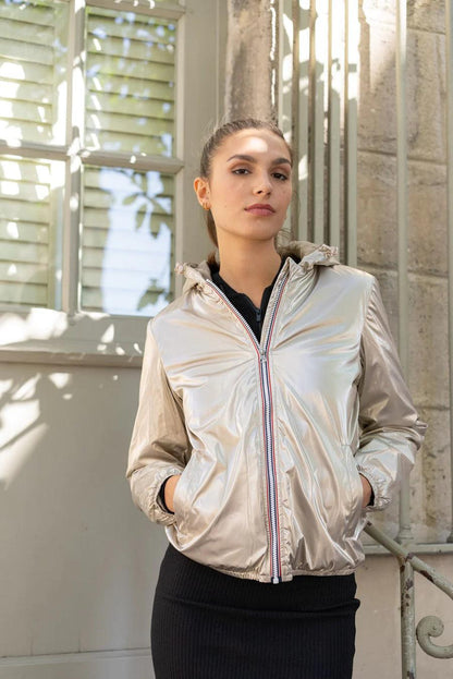 Woman wearing a shiny gold Laura Jo short waterproof jacket, Le Petit Placard collection