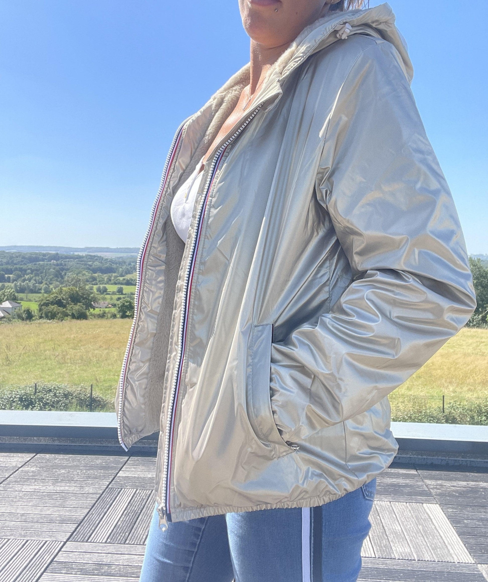 Woman wearing a metallic gold Laura Jo short waterproof jacket outdoors, Le Petit Placard.