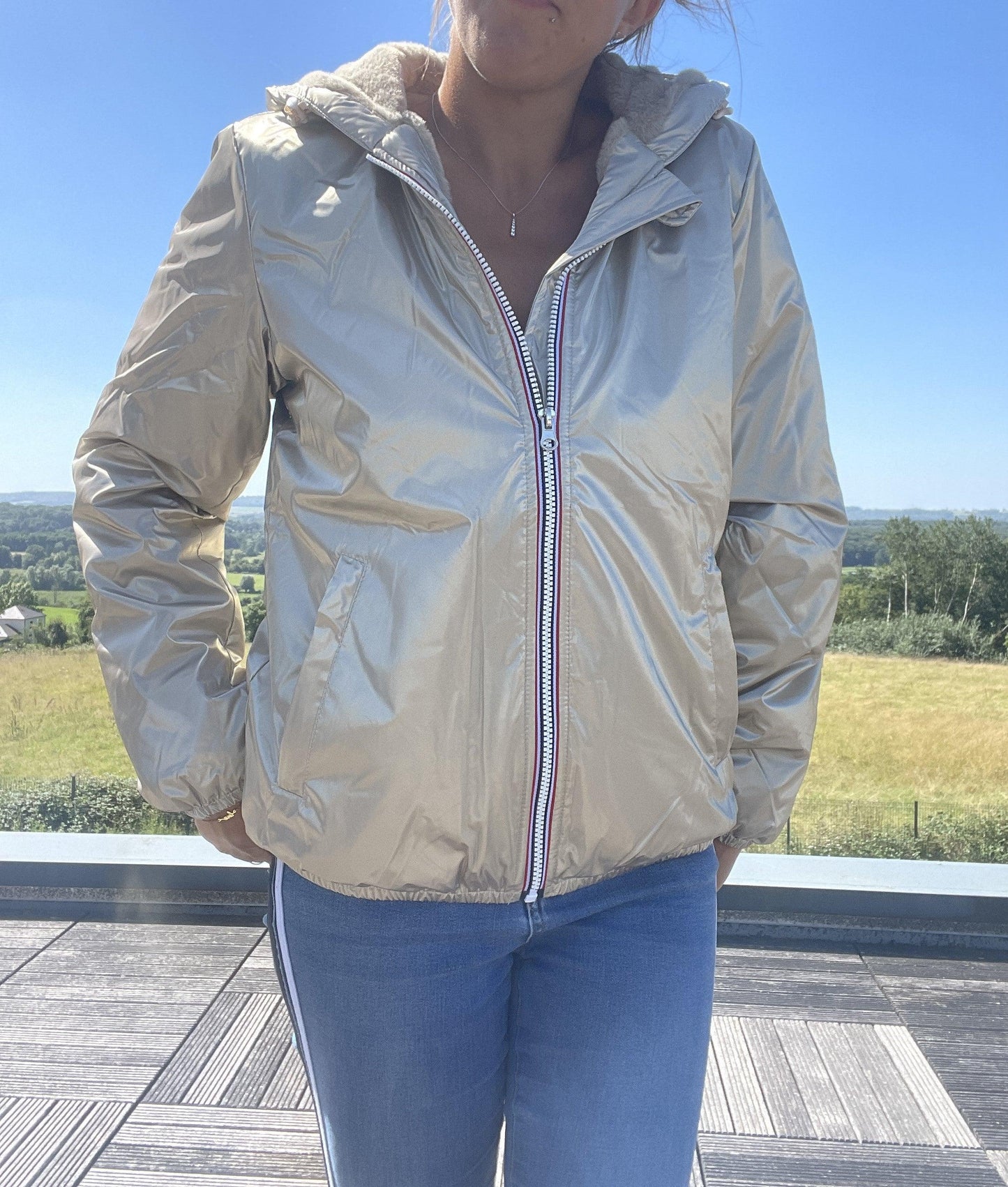 Woman wearing short gold Laura Jo waterproof jacket outdoors, Le Petit Placard fashion