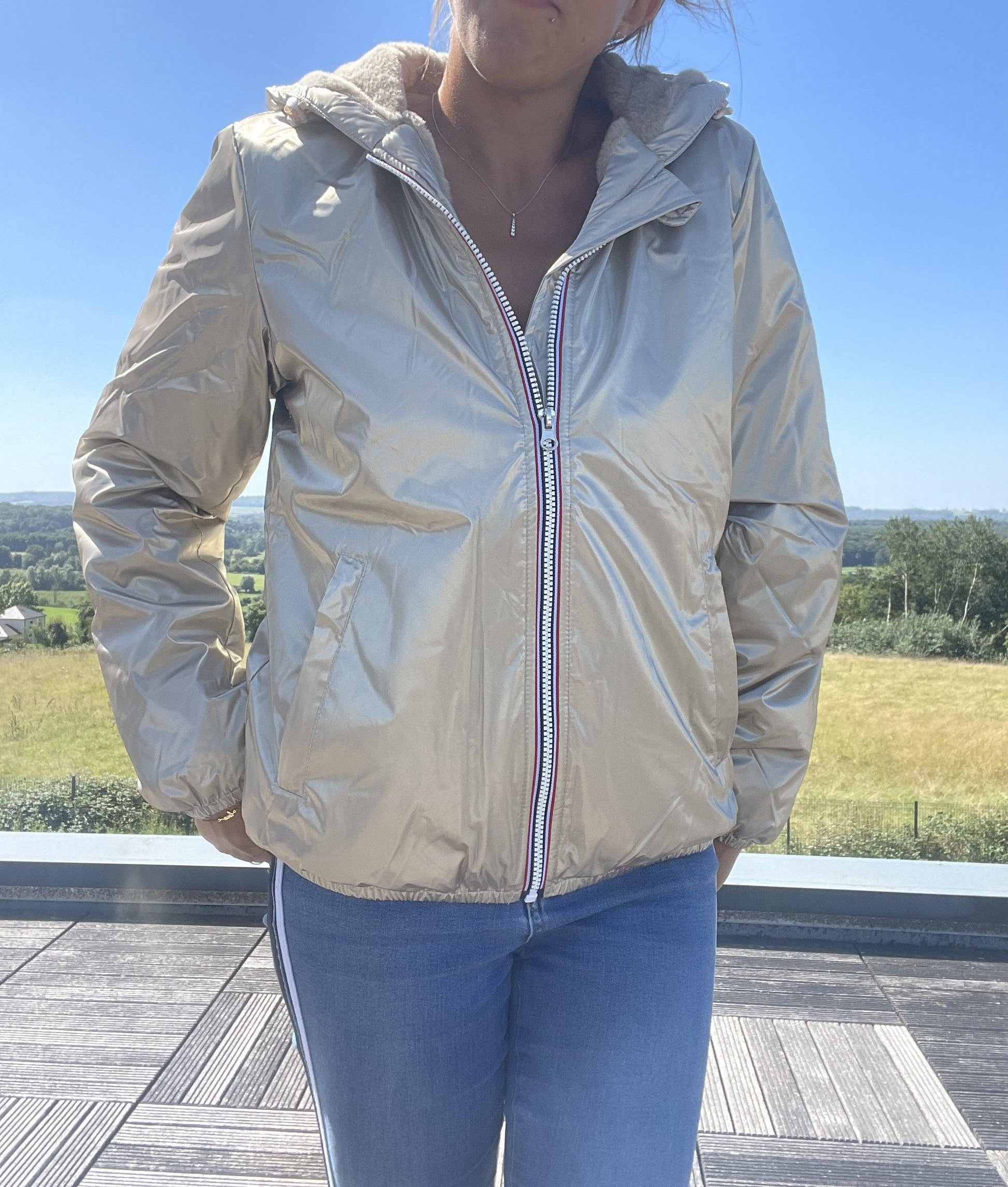 Woman wearing short gold Laura Jo waterproof jacket outdoors, Le Petit Placard fashion