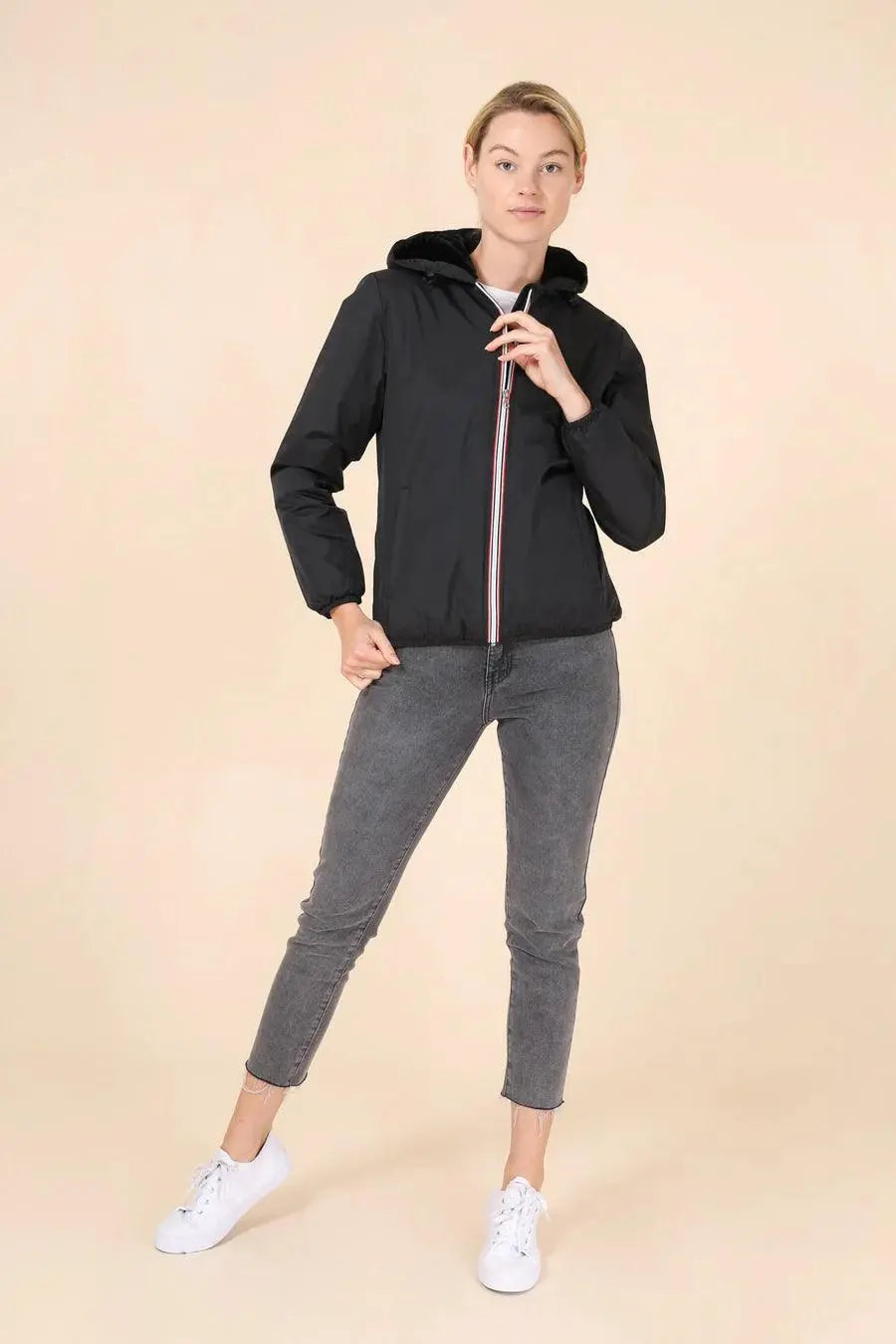 Woman wearing Laura Jo short black waterproof jacket with hood from Le Petit Placard