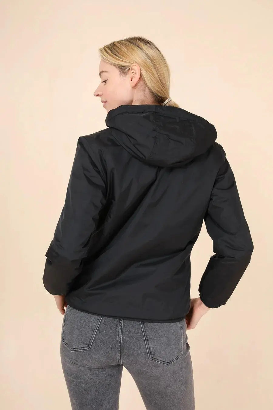 Woman in black Laura Jo short waterproof jacket from Le Petit Placard, back view
