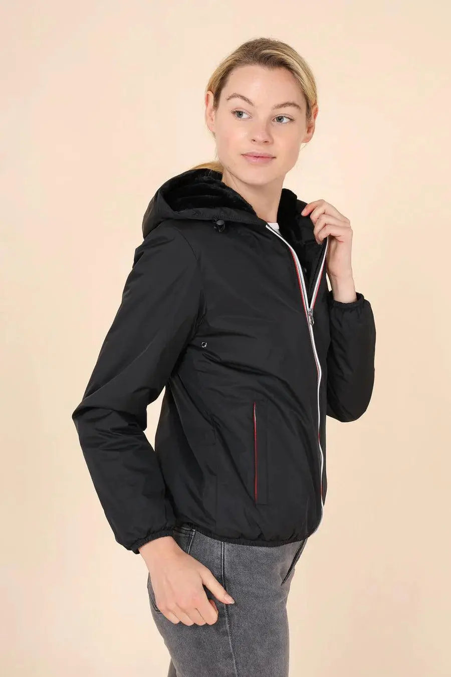 Woman wearing Laura Jo black short waterproof jacket with hood from Le Petit Placard