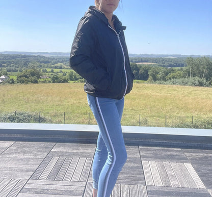 Woman in a short black Laura Jo raincoat and jeans outdoors, Le Petit Placard fashion