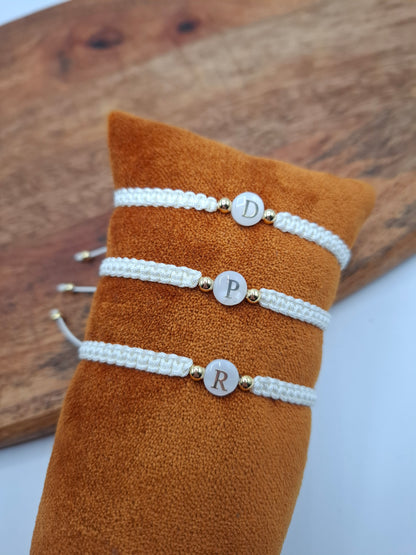 White woven initial bracelets with gold beads on orange display, Le Petit Placard accessories