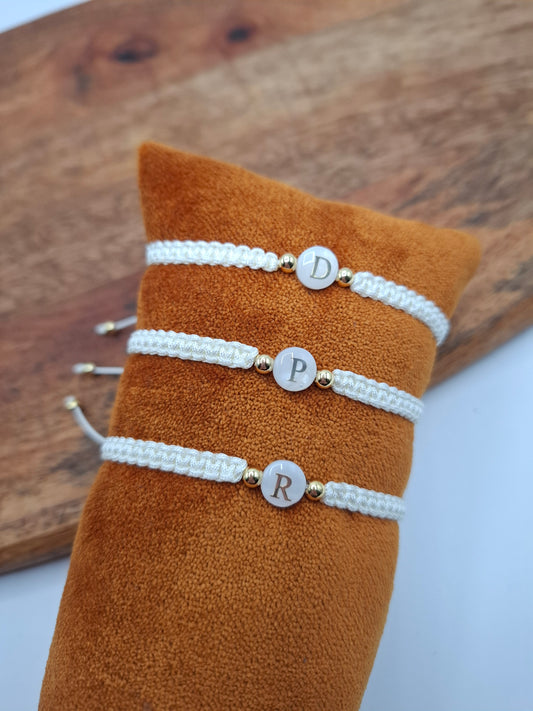 White woven initial bracelets with gold beads on orange display, Le Petit Placard accessories
