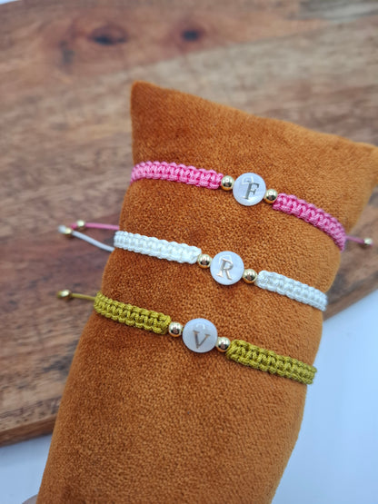 Personalized macrame bracelets with initials F, R, V on display at Le Petit Placard