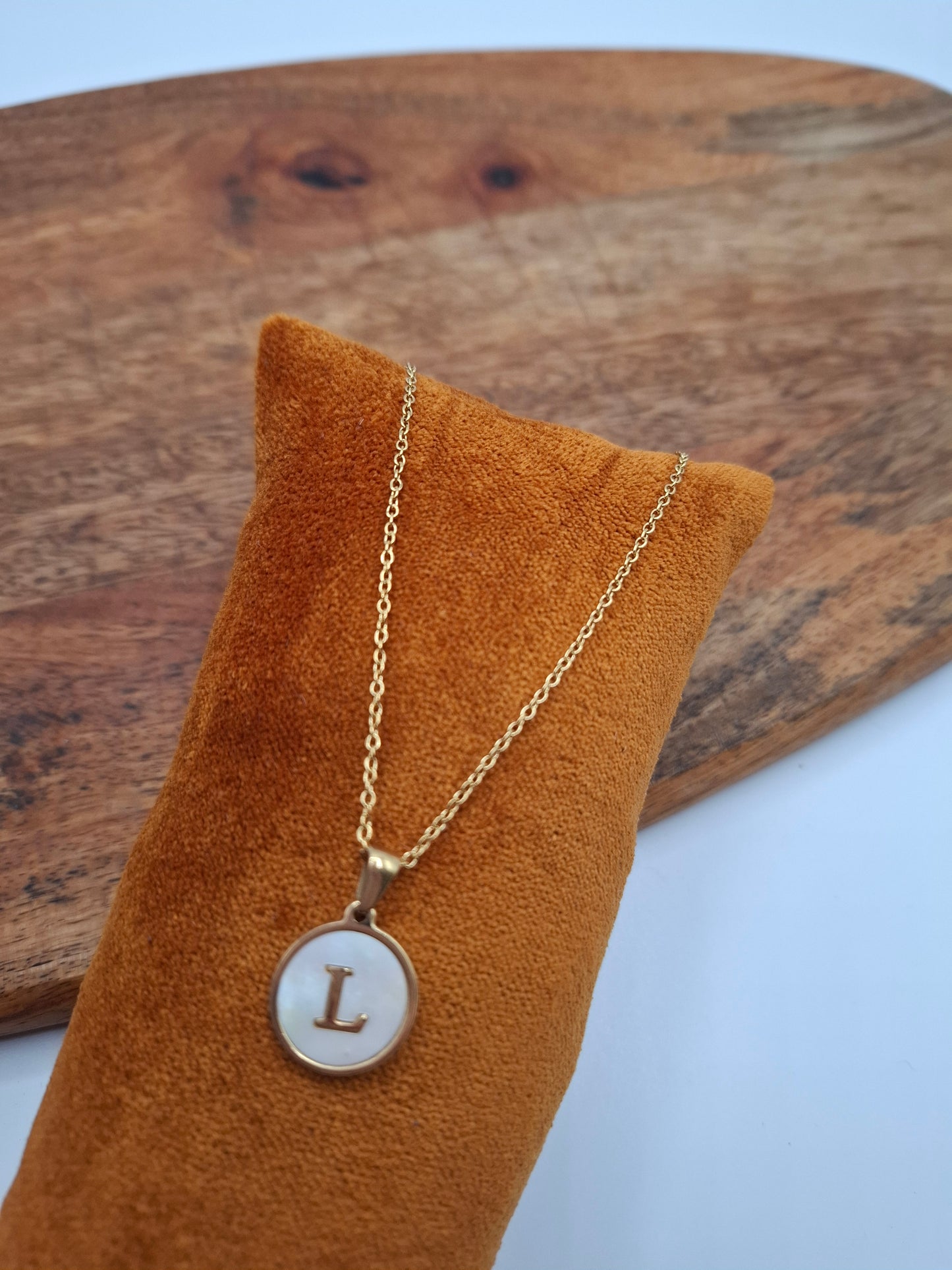 Gold initial L pendant necklace on velvet display, Le Petit Placard trendy accessory