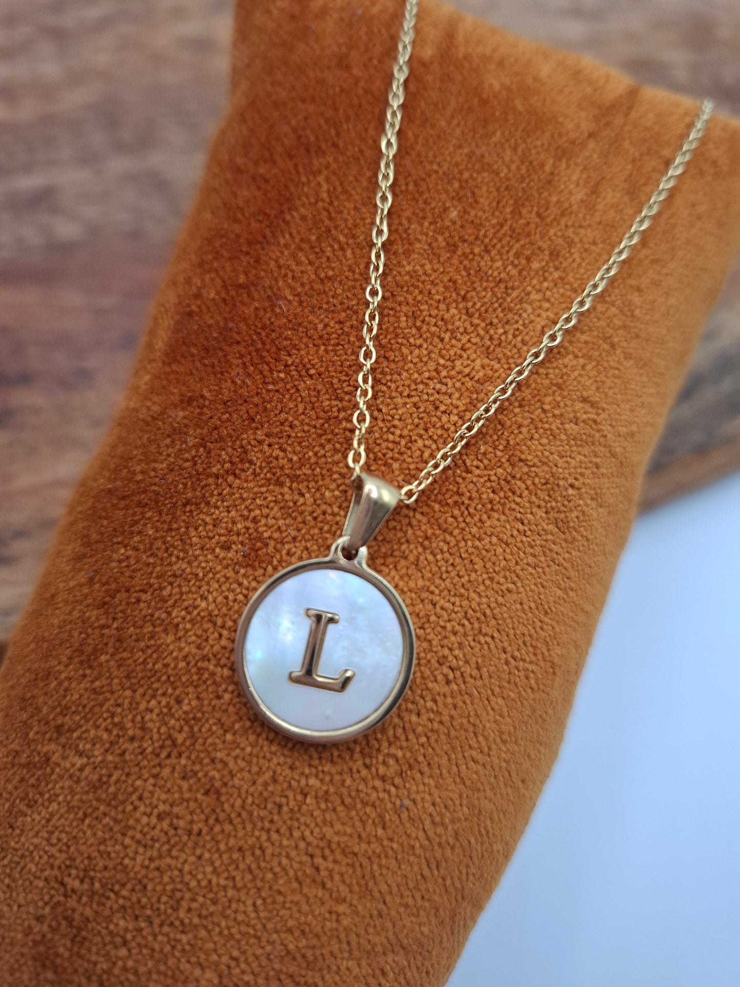 Gold necklace with round mother-of-pearl pendant featuring letter L, Le Petit Placard jewelry