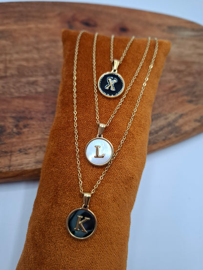 Gold initial pendant necklaces X, L, K on velvet display, Le Petit Placard jewelry accessory