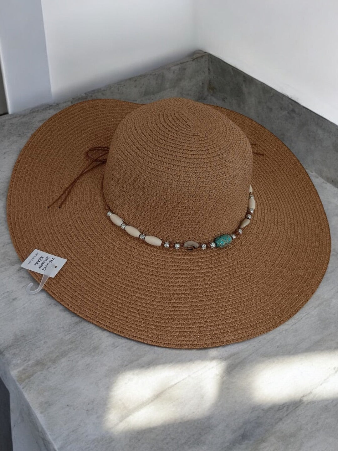 Brown wide-brimmed capeline hat with shell and bead band, Le Petit Placard accessory