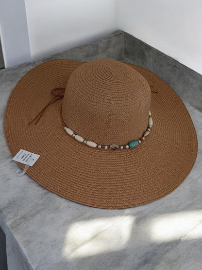Brown wide-brimmed capeline hat with shell and bead band, Le Petit Placard accessory