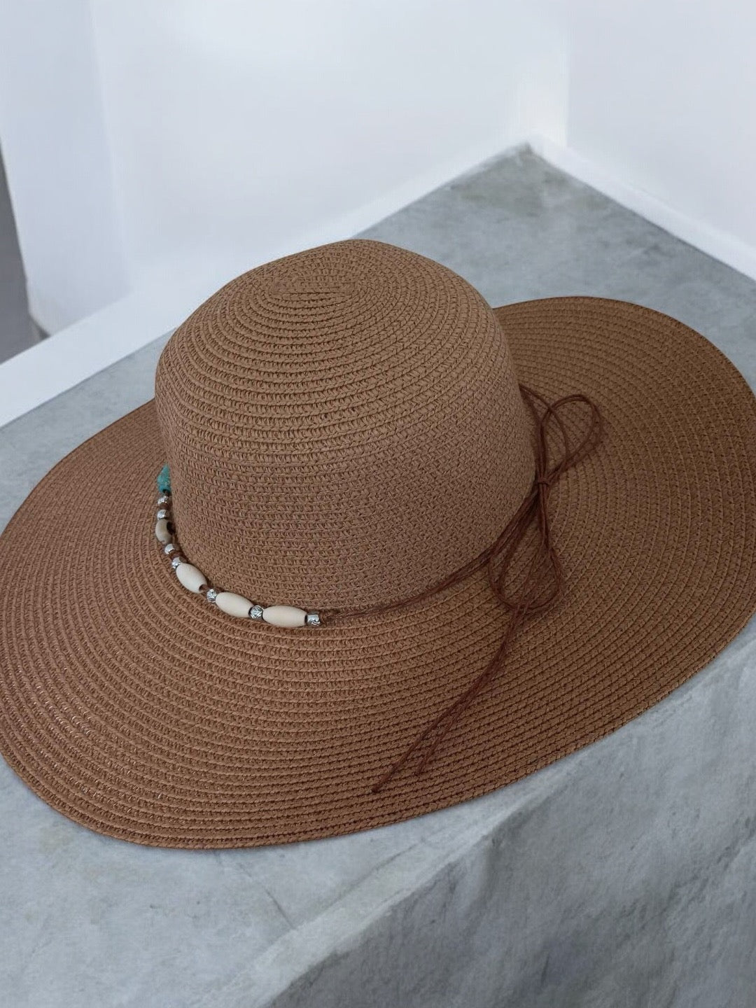 Brown capeline hat with bead detailing, stylish accessory from Le Petit Placard