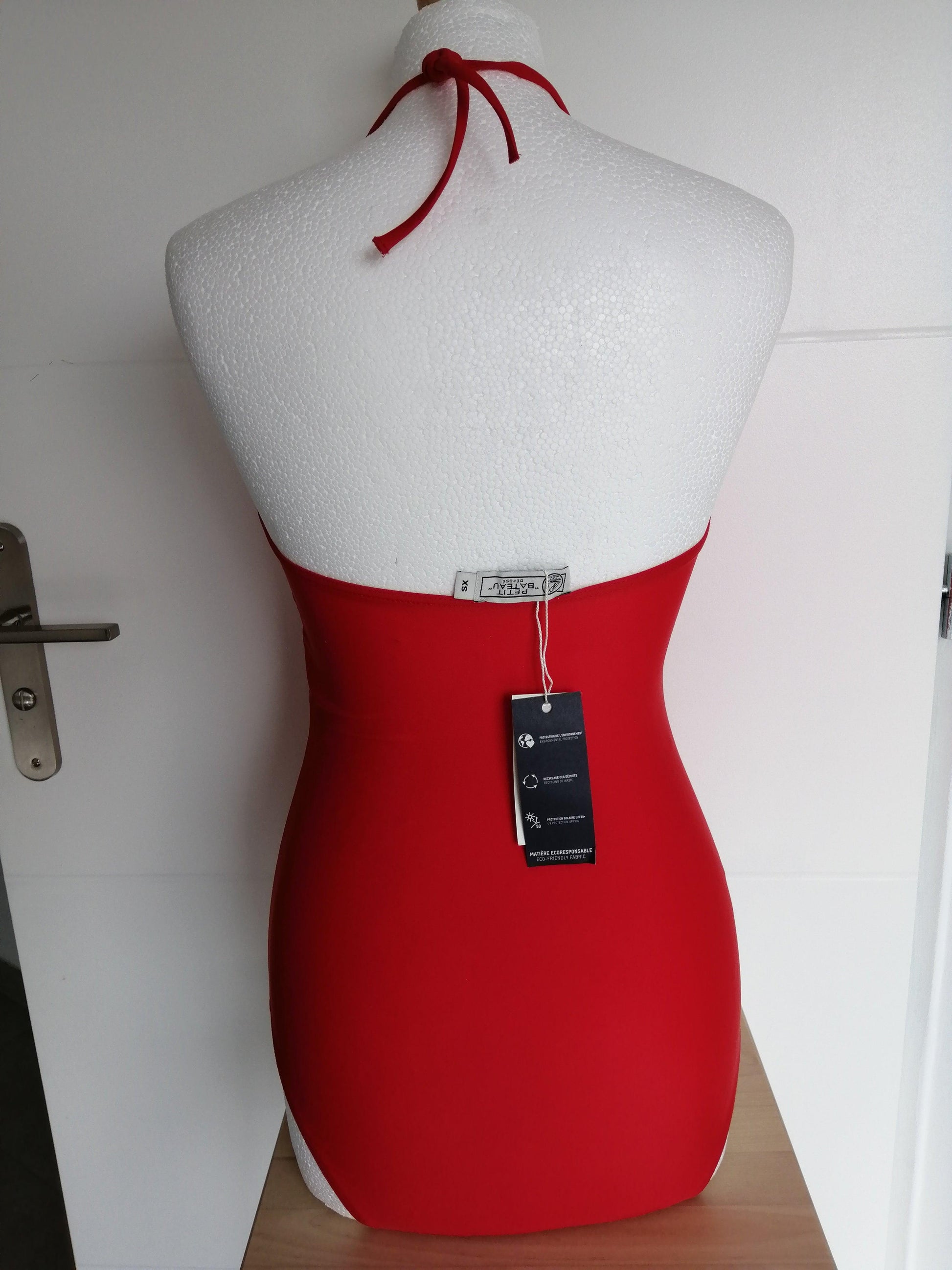 Red one-piece swimsuit with halter straps on mannequin, Le Petit Placard boutique